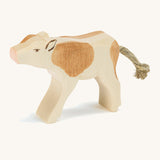 A brown wooden Ostheimer calf drinking figure on a cream background.