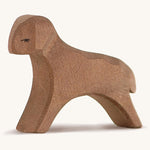 A brown wooden running Ostheimer lamb figure on a cream background.