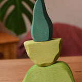 Ostheimer light, middle and dark green wooden bush scenery pieces stacked on top of each other.