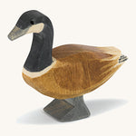A wooden standing Ostheimer Canadian goose on a cream background.