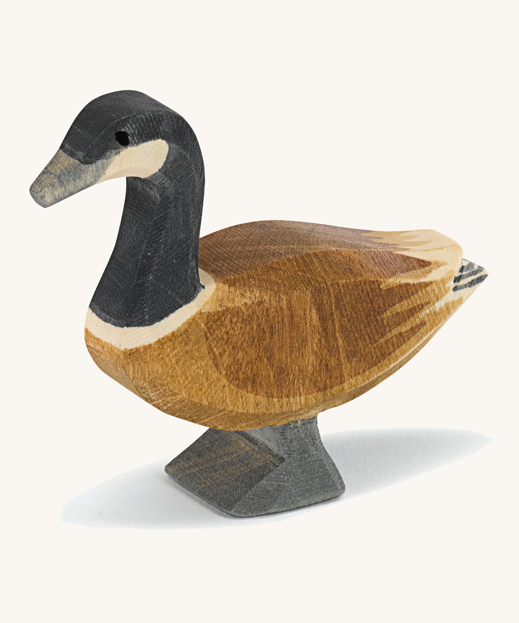 A wooden standing Ostheimer Canadian goose on a cream background.