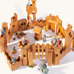 Ostheimer children's wooden castle set laid out on a beige background