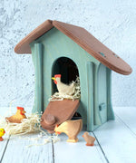 A wooden Ostheimer chicken house with Ostheimer chickens and hens outside