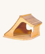 A wooden Ostheimer cottage on a cream background.