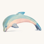 A wooden Ostheimer diving dolphin figure on a cream background.