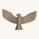 A wooden brown Ostheimer eagle with its wings spread out on a cream background. 