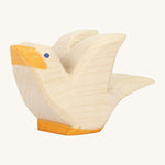 A white wooden Ostheimer flying pigeon figure on a cream background.