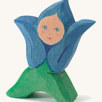 A wooden Ostheimer gential flower child figure on a cream background.