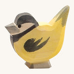 A wooden Ostheimer goldfinch bird figure on a cream background