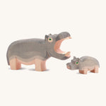 Wooden adult and small Ostheimer figures on a cream background.