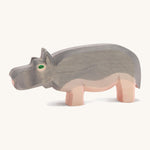 A wooden Ostheimer hippo figure on a cream background.