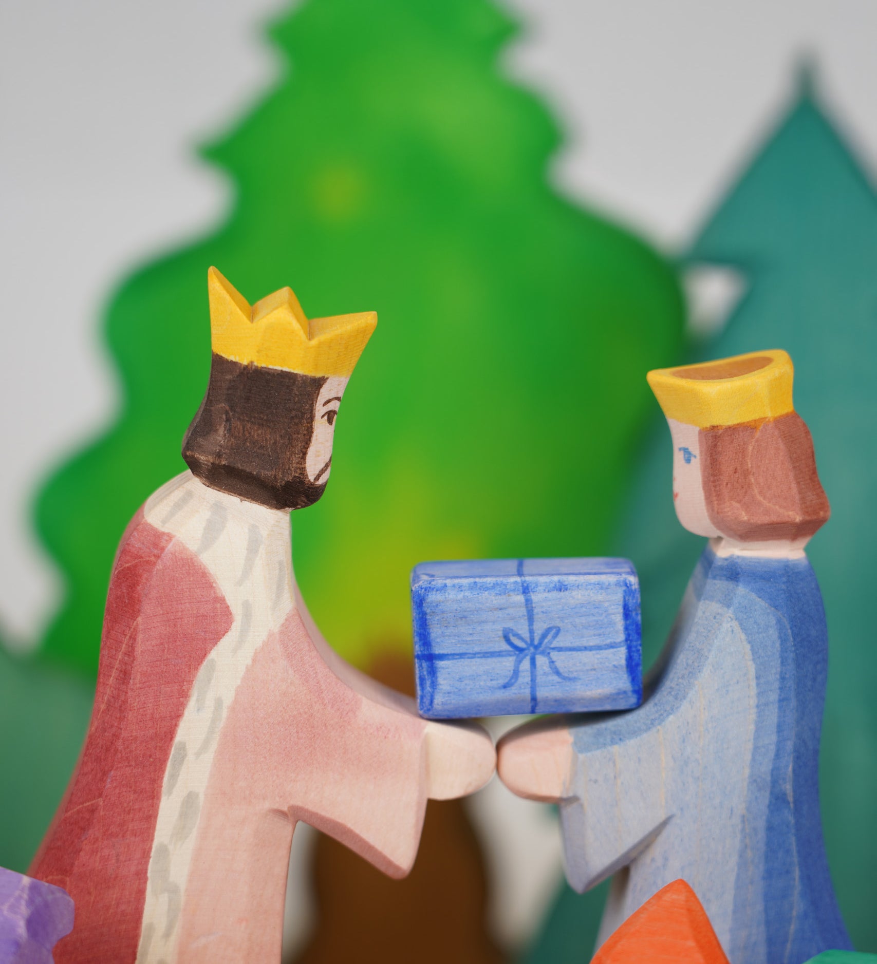 Ostheimer King and Qieen wooden toy figures, handmade in Germany, exchanging a small blue gift, Waldorf and small world play scene, sold at Babipur