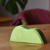 Ostheimer light green wooden bush scenery piece placed on a wooden surface.