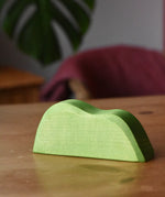 Ostheimer light green wooden bush scenery piece placed on a wooden surface.
