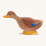 A brown wooden Ostheimer duck with a long neck on a cream background