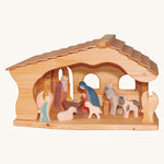 Ostheimer Nativity Stable on a plain background. The stable is filled with nativity figures. 