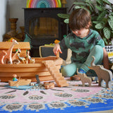 A child playing with the Ostheimer wooden Noah’s Ark with hand-painted animals and figures. Made in Germany this is ideal for small world storytelling and open-ended play, sold at Babipur