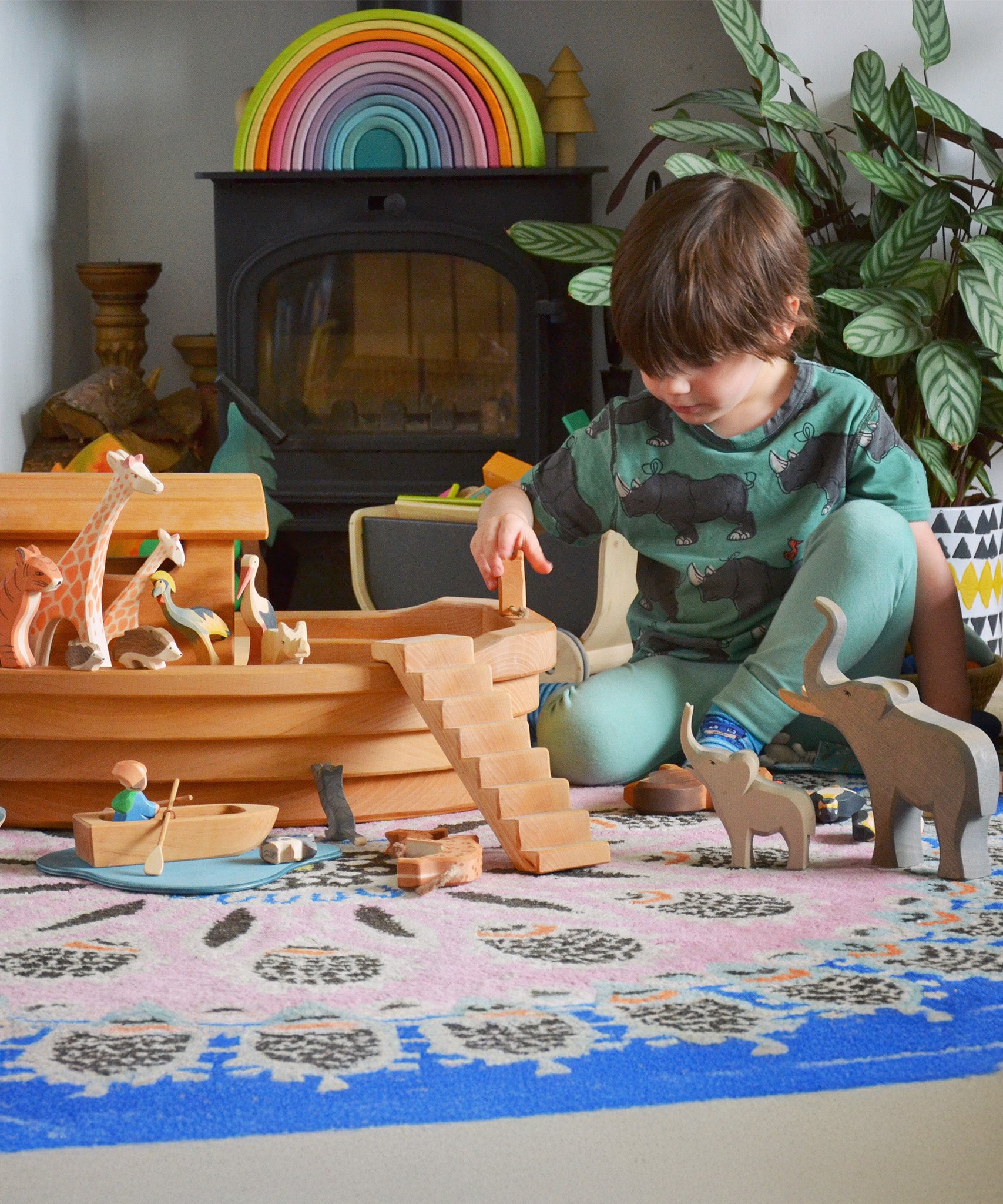 A child playing with the Ostheimer wooden Noah’s Ark with hand-painted animals and figures. Made in Germany this is ideal for small world storytelling and open-ended play, sold at Babipur