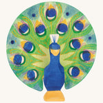 A wooden Ostheimer peacock figure with its wings open on a cream background.