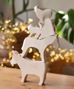 Five Ostheimer paint your own wooden figures stacked on top of each other, cow, horse, dog, standing cat and cockerel.