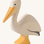 A wooden Ostheimer pelican figure on a cream background.