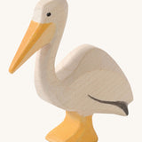 A wooden Ostheimer pelican figure on a cream background.