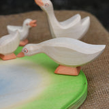 A close up of an Ostheimer goose placed on the side of the wooden pond scenery piece. 