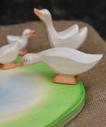A close up of an Ostheimer goose placed on the side of the wooden pond scenery piece. 