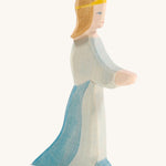 A wooden Ostheimer queen figure wearing a blue flowing dress and yellow tiara on a cream background.