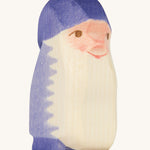 A purple wooden Ostheimer dwarf figure on a cream background.