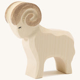 A white wooden Ostheimer standing ram figure on a cream background.