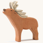 A wooden Ostheimer red deer stag figure on a cream background.