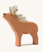 A wooden Ostheimer red deer stag figure on a cream background.