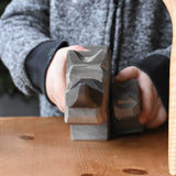 A front profile view of the large and small Ostheimer rhino wooden toy figures. These wooden figures are part of a wide range of expertly hand crafted wooden toys here at Babipur.