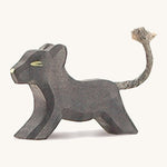 A small wooden Ostheimer running panther on a cream background.