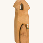 A Ostheimer wooden Ostheimer sentry tower with a bell on a cream background.