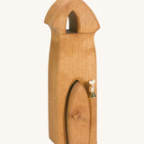 A Ostheimer wooden Ostheimer sentry tower with a bell on a cream background.