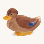 A brown wooden sitting Ostheimer duck figure on a cream background.