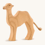 A small wooden Ostheimer camel on a cream background.