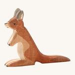 A small wooden Ostheimer kangaroo figure on a cream background.