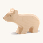 A small wooden Ostheimer polar bear figure with a long neck on a cream background.