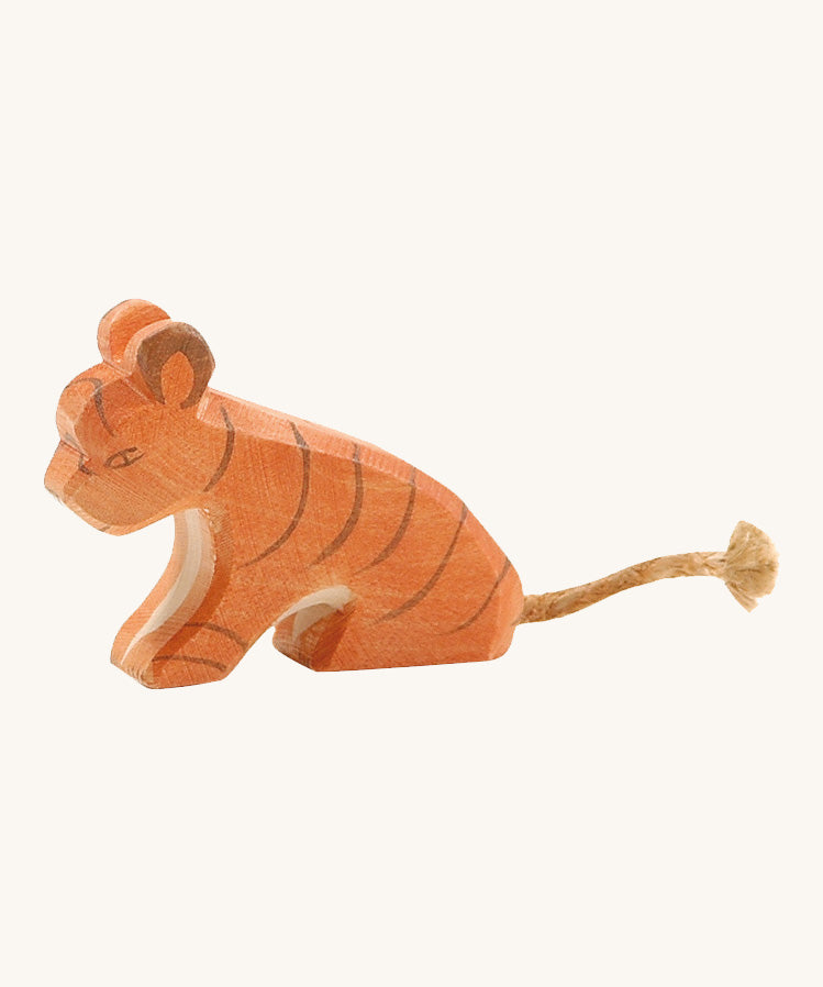 A small sitting Ostheimer tiger figure on a cream background.