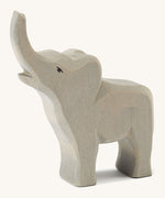 A small wooden trumpeting Ostheimer figure on a cream background.