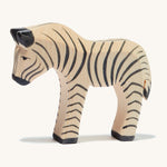 A small wooden Ostheimer figure on a cream background.