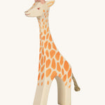 A wooden standing Ostheimer giraffe figure on a cream background.