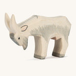 A grey and white wooden Ostheimer goat figure on a cream background.