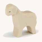 A white wooden Ostheimer standing sheep on a cream background.