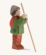 A wooden standing Ostheimer shepherd figure holding a wooden staff on a cream background.
