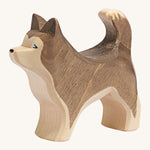 A dark brown wooden Ostheimer standing sled dog on a cream background.