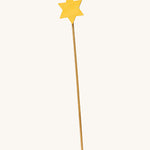 A wooden Ostheimer staff with a yellow star on the top for the Ostheimer angel on a cream background.